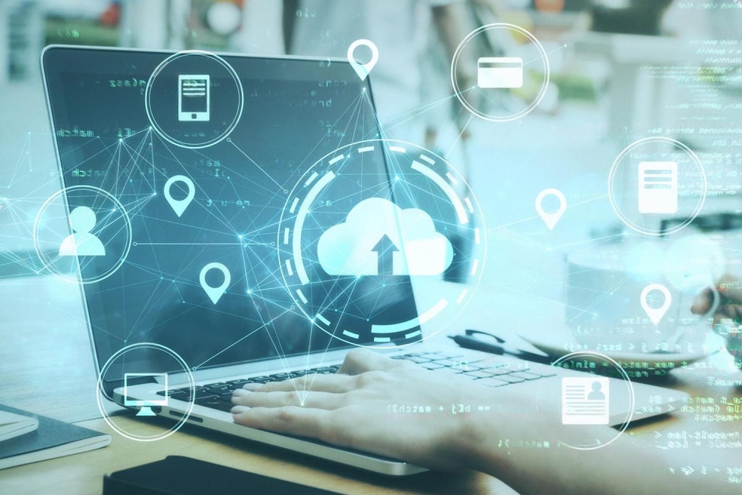 Laptop on a desk surrounded by cloud computing icons illustrating cloud migration planning